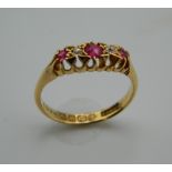 An Edwardian 18 ct gold ruby and diamond gypsy ring. Ring Size M.