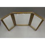 A gilt framed triptych mirror. 50.5 cm high.