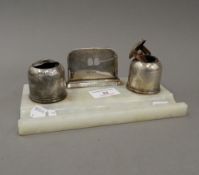 A silver and alabaster desk stand with inkwells. 19 cm wide.