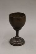 A polished coconut and turned wooden chalice. 18 cm high.