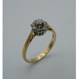 An 18 ct gold diamond flowerhead ring. Ring size O (2.