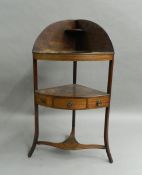 A Georgian mahogany corner washstand. 105.5 cm high.