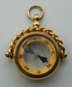 An 18 ct gold compass fob. 2.5 cm wide. 9.3 grammes total weight.