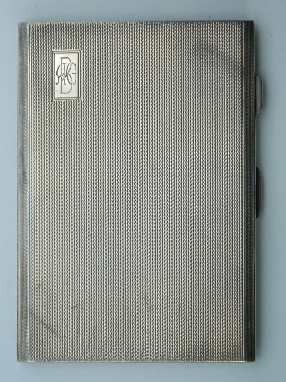 An engine turned hallmarked 1945 solid silver cigarette case. 12.5 cm wide. 6.7 troy ounces.