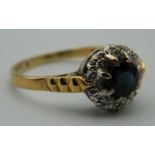 An 18 ct gold diamond and sapphire ring. Ring Size Q. 4.5 grammes total weight.