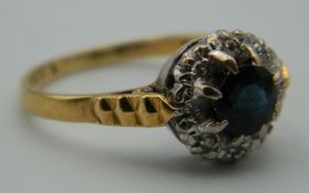 An 18 ct gold diamond and sapphire ring. Ring Size Q. 4.5 grammes total weight.