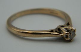 A 9 ct gold diamond solitaire ring. Ring Size O/P. 2.1 grammes total weight.