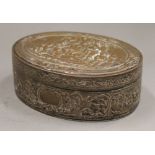 An embossed oval copper box. 13.5 cm wide.