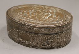 An embossed oval copper box. 13.5 cm wide.