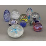 A collection of various glass paperweights