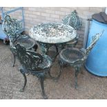 A Victorian cast iron pub table with associated top and a set of four cast iron garden chairs.