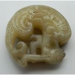 A Chinese carved jade roundel. 4.5 cm high.