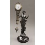 A swing clock formed as a classical maiden. 33.5 cm high.
