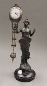 A swing clock formed as a classical maiden. 33.5 cm high.