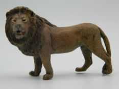 A cold painted bronze model of a lion. 9 cm long.