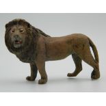 A cold painted bronze model of a lion. 9 cm long.