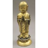 A gilt bronze model of buddha. 23.5 cm high.