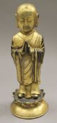 A gilt bronze model of buddha. 23.5 cm high.