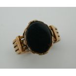 A 9 ct gold gentleman's signet ring set with blood stone. Ring Size U. 6.8 grammes total weight.