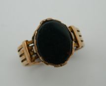 A 9 ct gold gentleman's signet ring set with blood stone. Ring Size U. 6.8 grammes total weight.