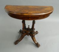 A Victorian walnut demi-lune card table. 89 cm wide.