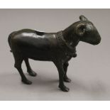 An Archaistic style patinated bronze model of a ram. 17.5 cm long.