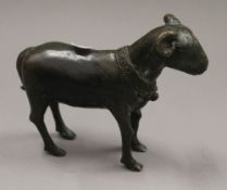 An Archaistic style patinated bronze model of a ram. 17.5 cm long.