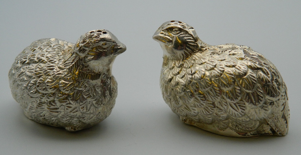 A pair of silver plate cruets formed as partridges. Each 6 cm long.