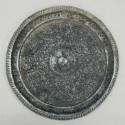 An Eastern embossed silver tray. 26 cm diameter. 11.9 troy ounces.