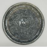 An Eastern embossed silver tray. 26 cm diameter. 11.9 troy ounces.