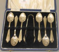 A cased set of silver teaspoons and a silver tong