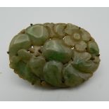 A Chinese silver mounted carved jade brooch with clip fitting. 5.5 cm wide.