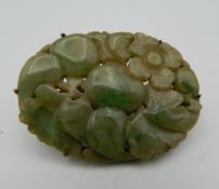 A Chinese silver mounted carved jade brooch with clip fitting. 5.5 cm wide.