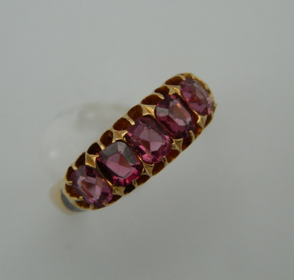 An 18 ct gold five stone pink topaz ring. Ring Size O. 4.2 grammes total weight.
