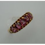 An 18 ct gold five stone pink topaz ring. Ring Size O. 4.2 grammes total weight.