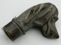 A bronze walking stick handle formed as a dog's head. 7 cm high.