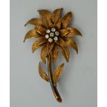 An 18 ct gold diamond flower form brooch. 5.5 cm high. 11.1 grammes total weight.