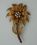 An 18 ct gold diamond flower form brooch. 5.5 cm high. 11.1 grammes total weight.