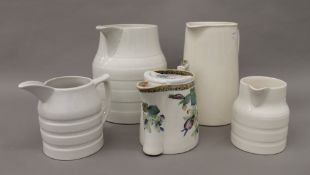 A quantity of porcelain dairy jugs, etc. The largest 22 cm high.