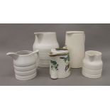 A quantity of porcelain dairy jugs, etc. The largest 22 cm high.