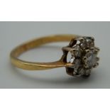 A 9 ct gold stone set flower head ring. Ring Size K. 2.6 grammes total weight.