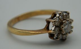 A 9 ct gold stone set flower head ring. Ring Size K. 2.6 grammes total weight.