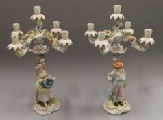 A pair of figural porcelain candelabra. 55 cm high.