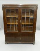 An early 20th century glazed oak bookcase. 107 cm wide.