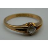 An 18 ct gold diamond solitaire ring. Ring Size N/O. 3 grammes total weight.