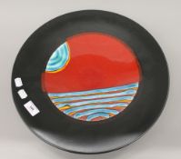 An unmarked Poole pottery charger. 41 cm diameter.