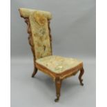 A 19th century tapestry covered walnut prie-dieu chair. 102 cm high.