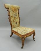 A 19th century tapestry covered walnut prie-dieu chair. 102 cm high.