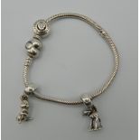 A Pandora silver bracelet and charms. 26.2 grammes. Approximately 16 cm long.