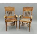 A pair of American oak open armchairs. 60 cm wide.